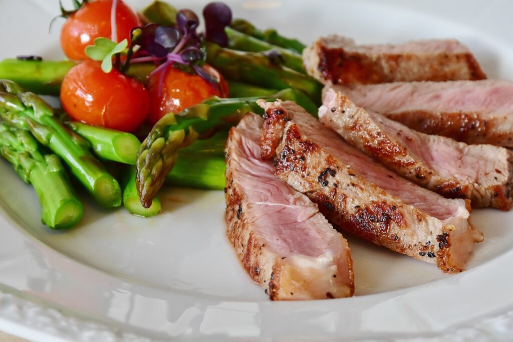 A plate of steak, asparagus and tomatoes - better than a vegan diet